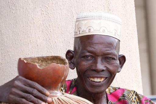 Man holding large shaker instrument